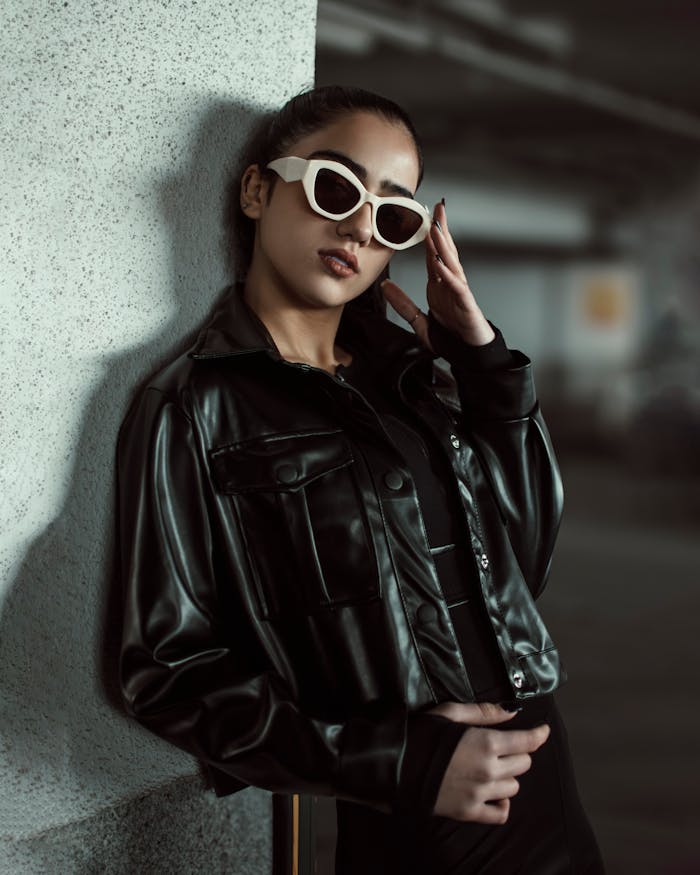 Crafting Captivating Headlines: Your awesome post title goes here Fashionable woman in black leather leaning on a wall, exuding confidence.
